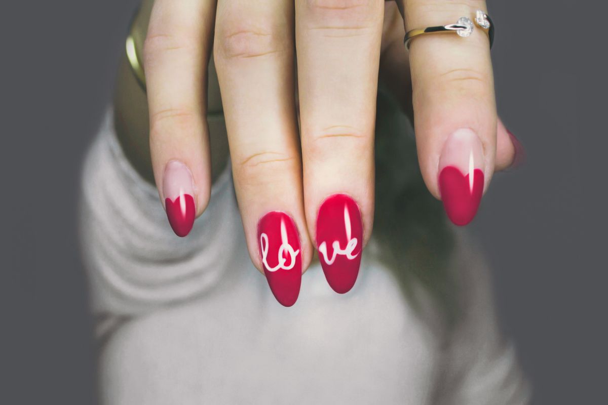 Red nail art design with lettering